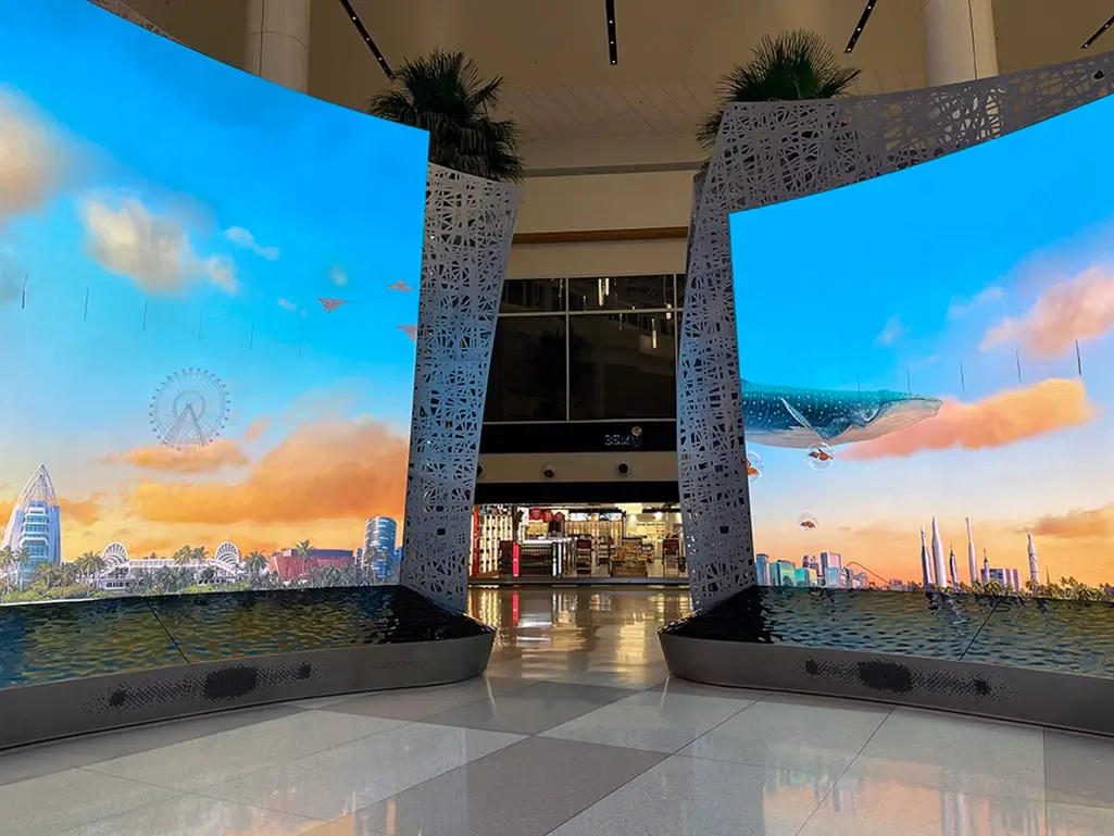 Curved Moment Vault LED video walls displaying an Orlando-themed scene at Orlando International Airport.