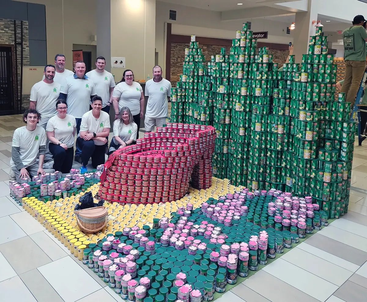 2025 CANstruction Wizard of Oz Team Poses Next To Display