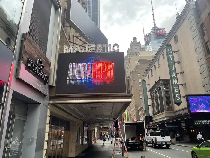 The exterior of the Majestic Theater on 44th Street, featuring a refurbished marquee with LED displays and an iconic blade sign