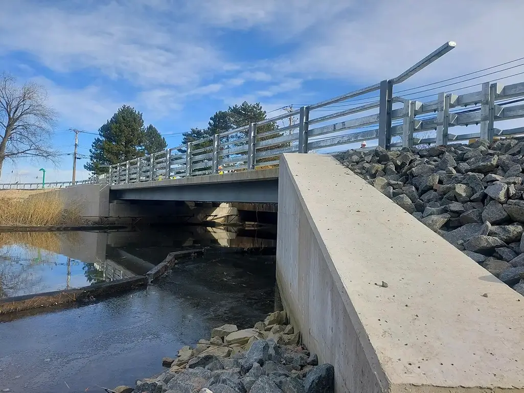 Grassy Point Road Bridge, a steel multi-girder bridge structure, over Minisceongo Creek with rip rap protection