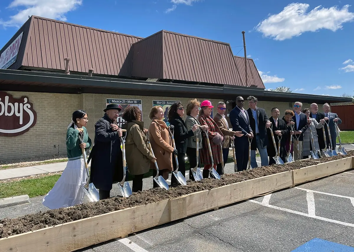 A diverse group of community members ceremoniously break ground on the New Cultural Center in Columbia, MD.