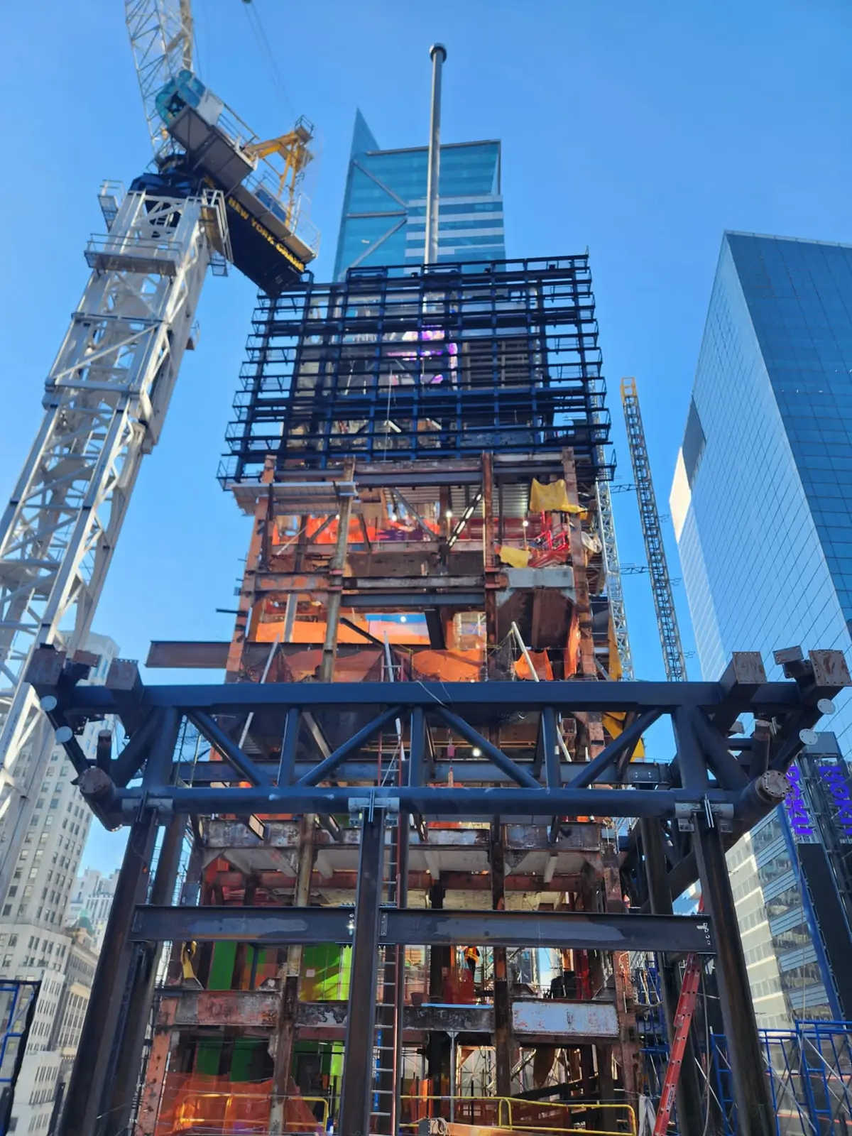 One Times Square under construction, featuring the tower crane and observation deck cantilever truss.